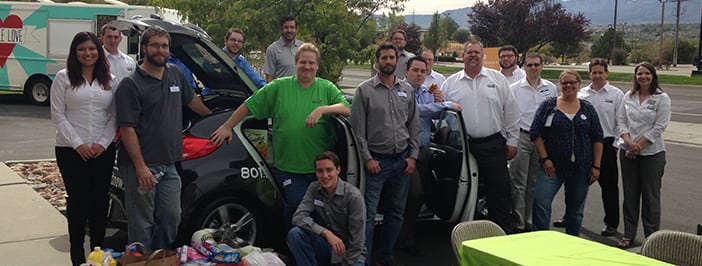 Team members in front of the I.T. Now car