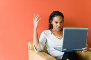 Frustrated woman looking at laptop