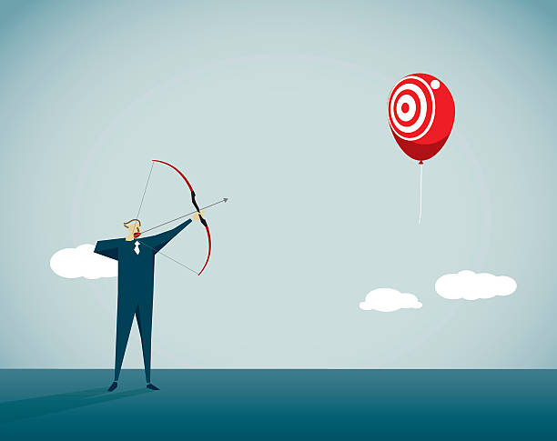 Man with bow and arrow shooting at ballon with target