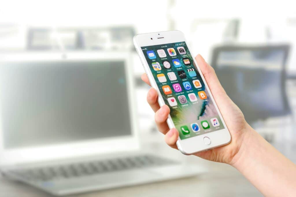 Person holding up a white iPhone